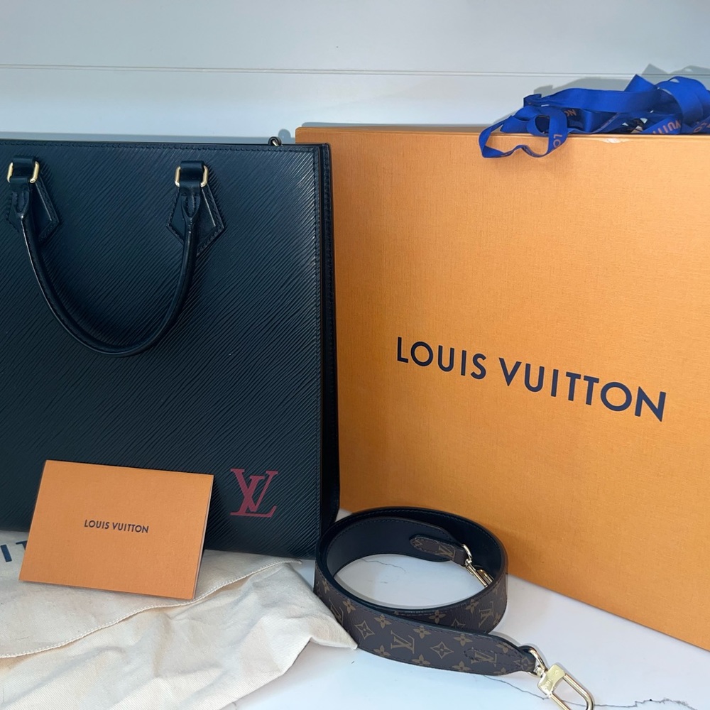 black with red emblem Louis Vuitton purse